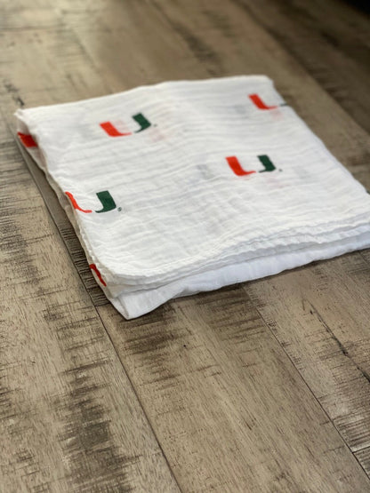 University of Miami Hurricanes Muslin Swaddle Blanket – Soft Breathable 47x47 Baby Blanket – Officially Licensed The U Newborn Gift